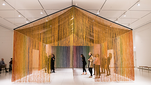Guests gather in a tent-like sculpture in the museum